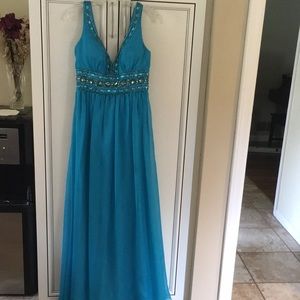 Gorgeous long dress in teal.  Used for prom. Altered size 10 to fit a size 4.